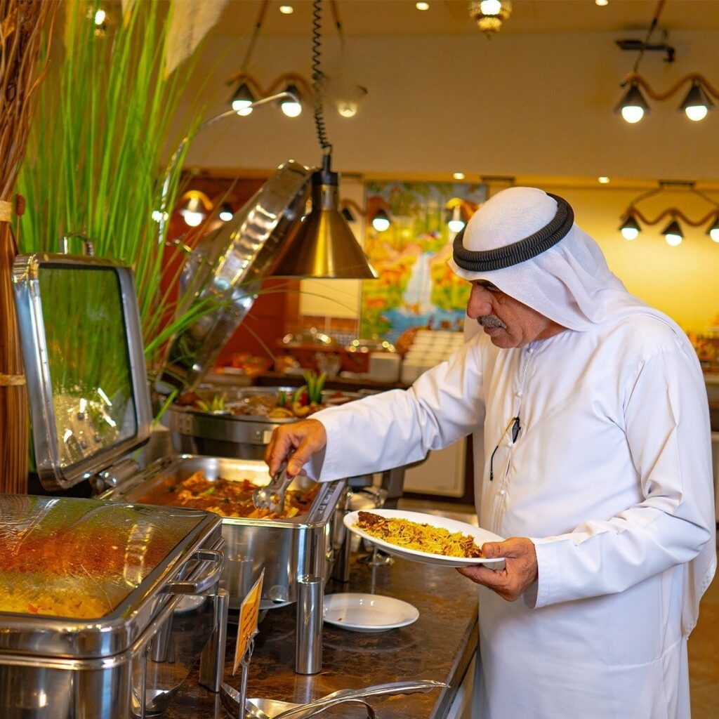 dinner buffet afab senior citizen picking food from buffet dish