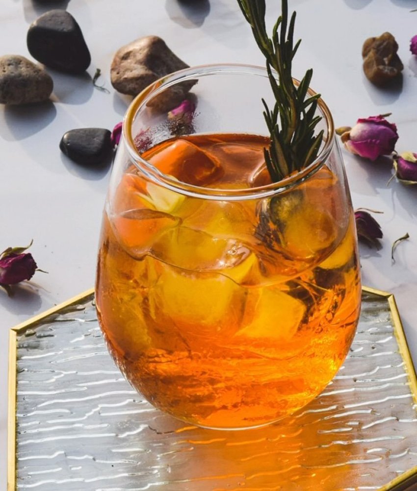 Refreshing iced herbal drink with rosemary garnish served over ice at Danial Star Restaurant